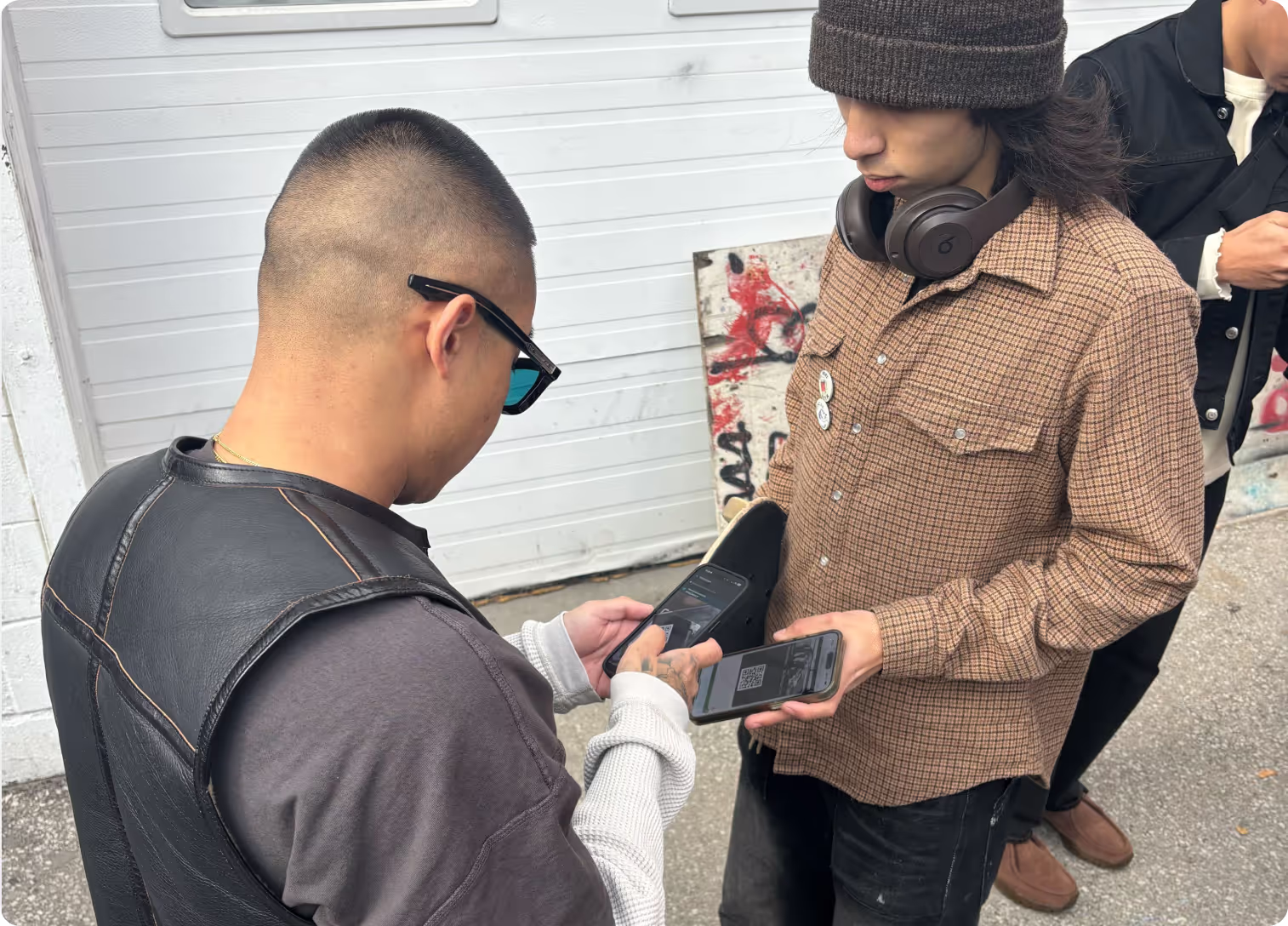 Angle staff scanning a Stüssy member pass at check-in